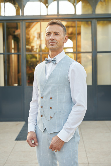 Zoom sur le gilet du costume GIORGIOC couleur bleu à carreaux. Elle comporte 6 boutons.