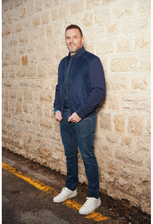 Homme portant le blouson suédine AMARIO marine. Il comporte 2 poches repose mains.