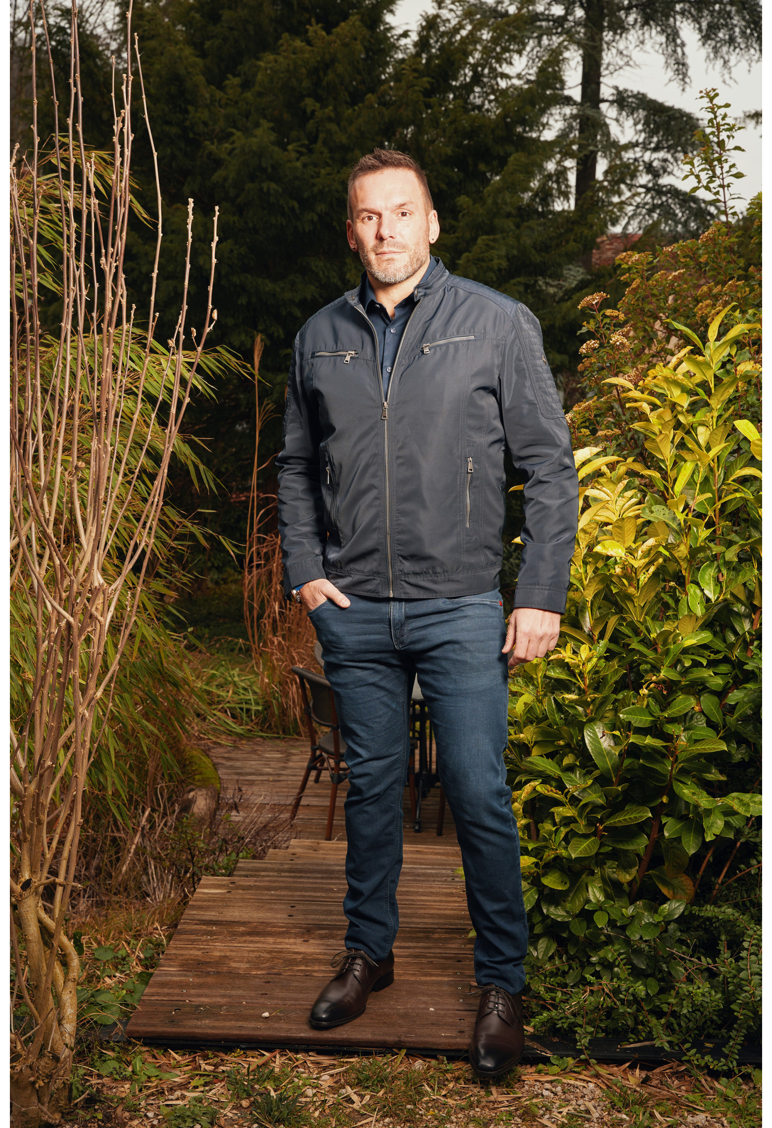 Homme portant le blouson LARIA marine. Il comporte 2 poches poitrine et et 2 poches repose mains.