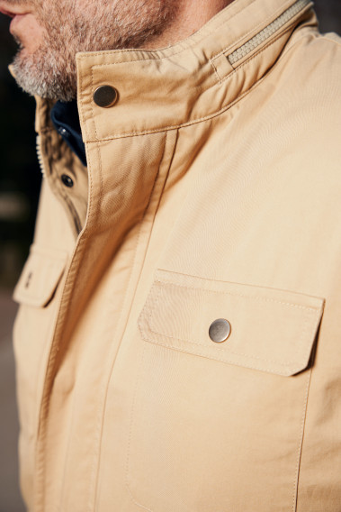 Homme portant la parka RIMINI beige. Elle comporte 2 poches poitrine.