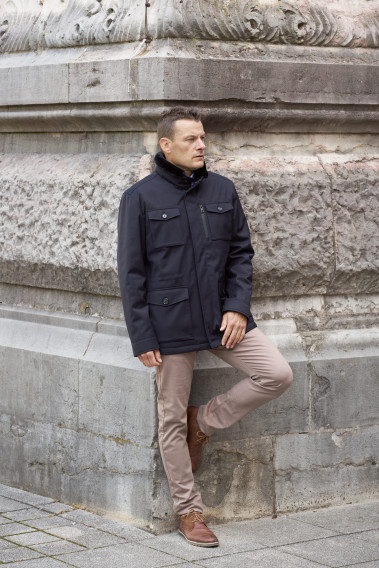 Homme portant la surveste TESS marine. Elle comporte 5 poches.