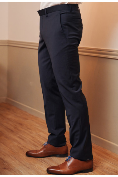 Zoom sur le pantalon du costume SULTAN marine. Il porte des chaussures marrons.