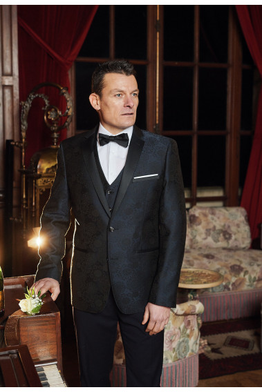 Homme portant la veste arabesque SANTIAGO arabesque noire. Elle comporte une poche poitrine et 2 poches .