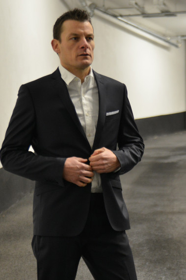 Homme portant la veste SULTAN noire. Elle comporte une poche poitrine et poches rabats.