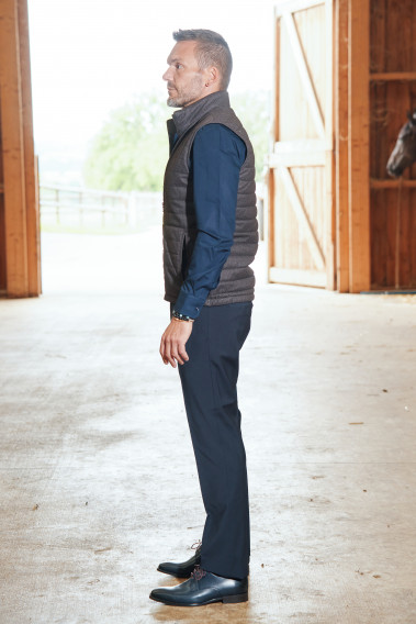 Homme de profil portant la doudoune sans manche KOS marron.