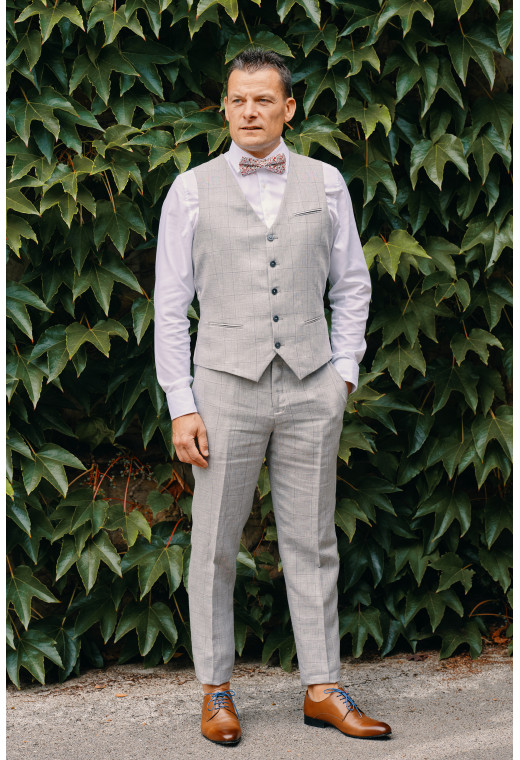 Homme portant le gilet  CHRIS gris à carreaux accompagné d'un nœuds papillon.