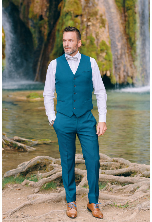 Homme portant le gilet CHRIS bleu-vert accompagné d'un nœuds papillon.