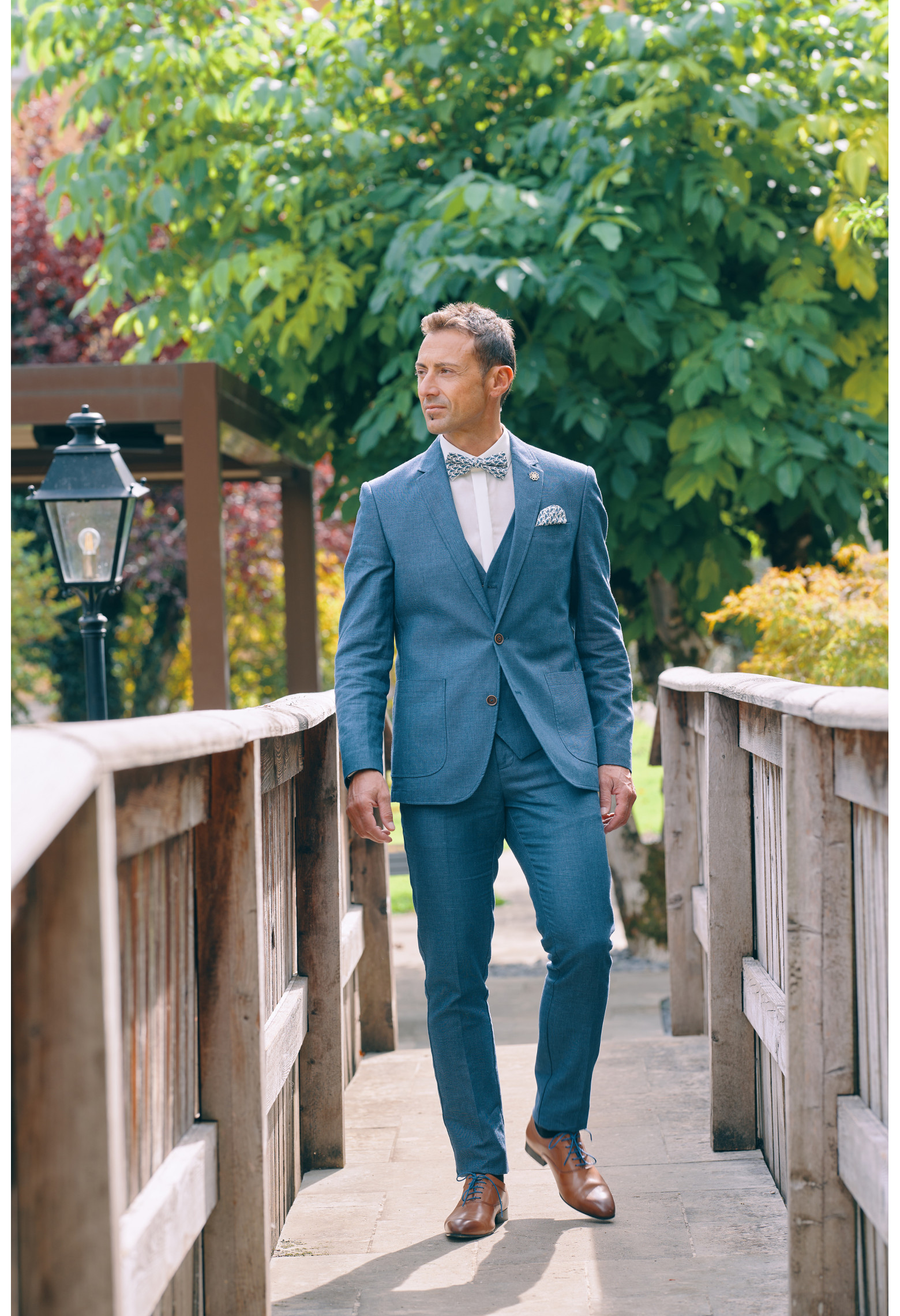 Homme portant la veste TROPICAL bleue. Elle comporte une poche poitrine et 2 poches  plaquées.