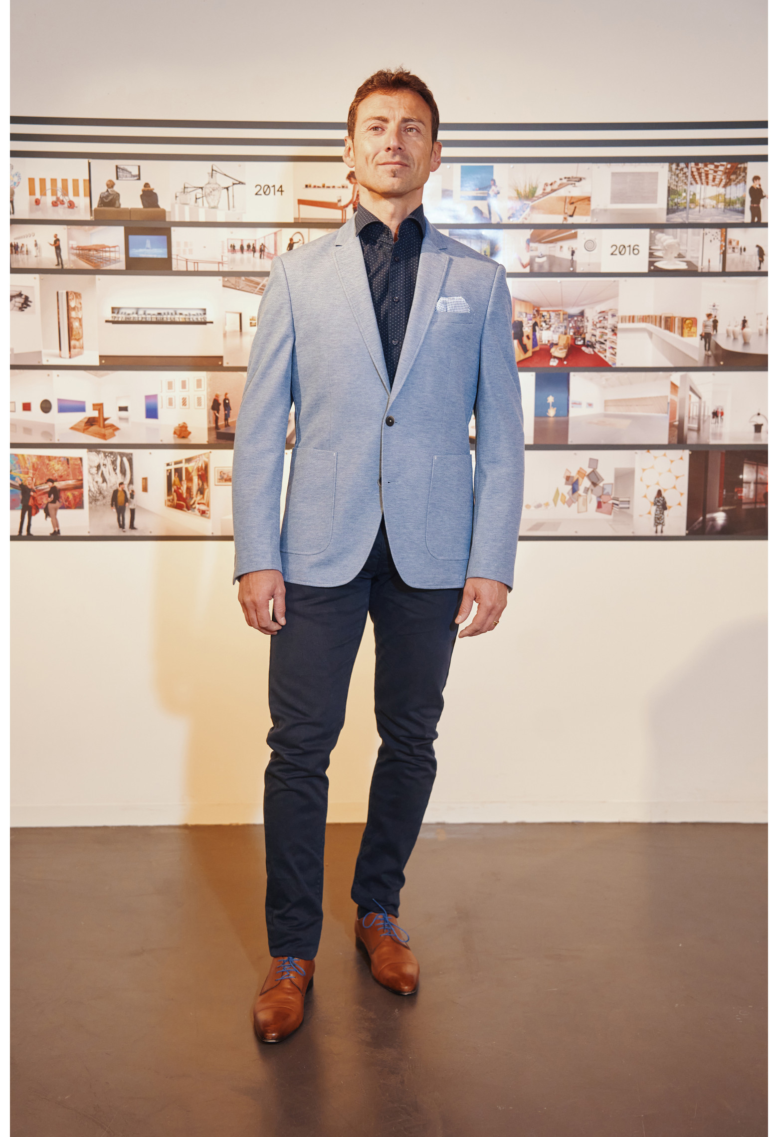 Homme portant la veste VALENTINA bleu clair. Elle comporte une poche poitrine et 2 poches plaquées.