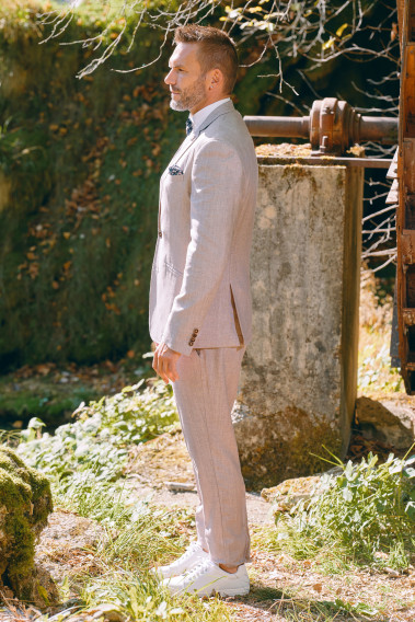 Homme de profil portant la veste TROPICAL rose poudré.