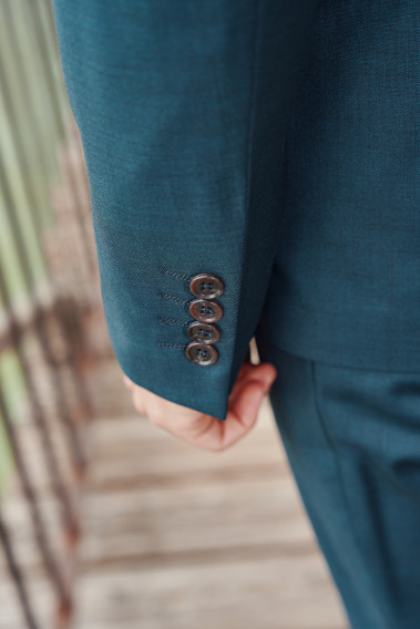 Zoom sur la manche du costume CITIZEN bleu vert. Elle comporte 4 boutons.