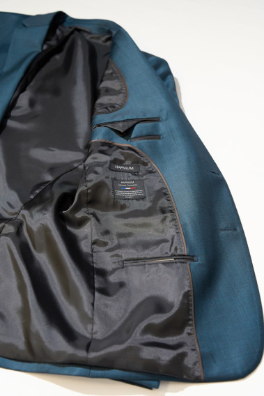 Zoom sur l'intérieur du costume CITIZEN bleu vert. Il comporte 3 poches intérieures.
