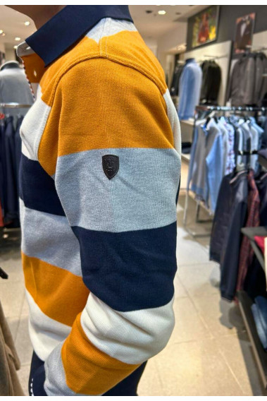 Homme de profil portant le polo manches longues ocre à rayures. Coupe classique.