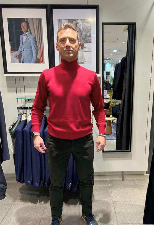 Homme portant le col roulé rouge. Coupe regular.