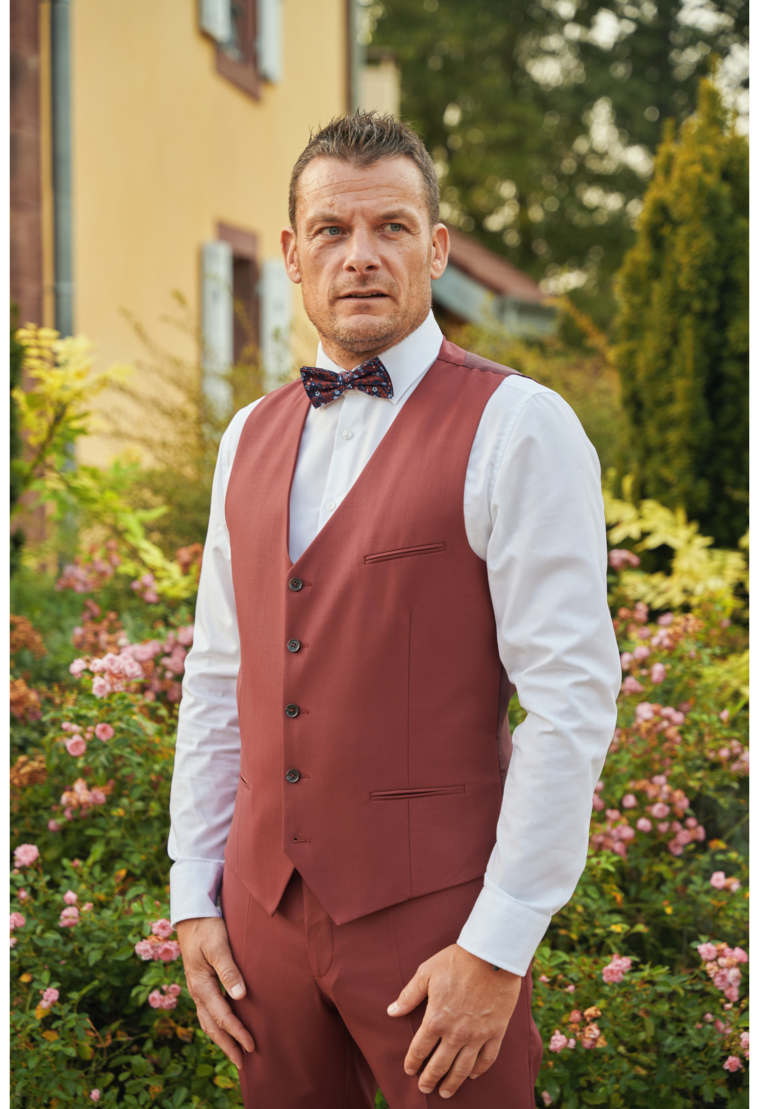 Homme portant le gilet CHRIS framboise accompagné d'un nœuds papillon.