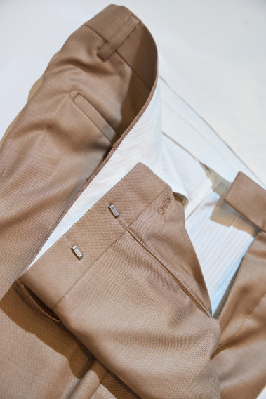 Zoom sur l’intérieur du pantalon du costume SUAT couleur beige foncé. La doublure est blanche.