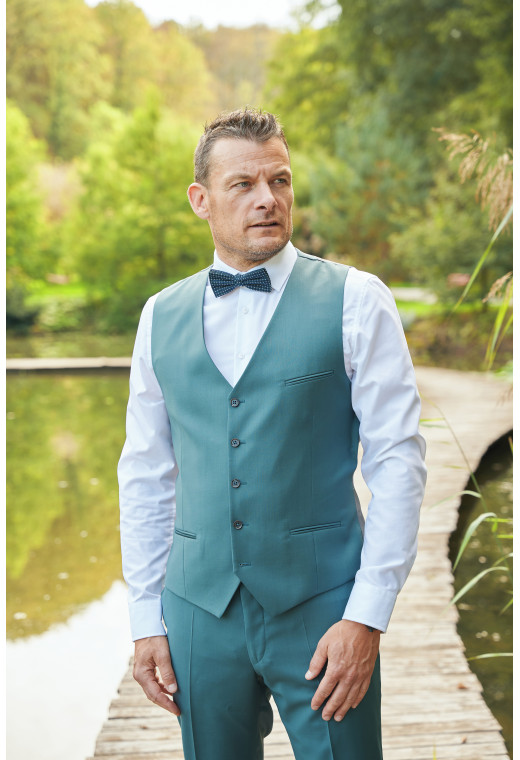 Homme portant le gilet CHRIS vert bleuté accompagné d'un nœuds papillon.